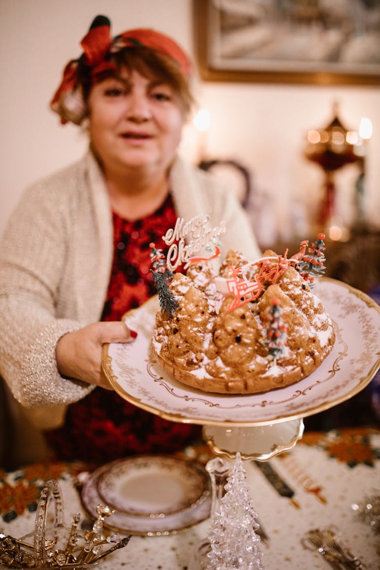 Woman Holding A Plate With Christmas Cake