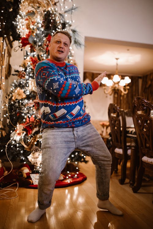 A Man in Christmas Sweater Dancing