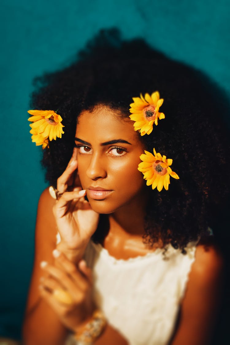 A Portrait Of A Young Woman With Sunflowers In Her Hair