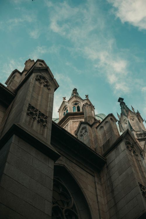 Free Low-angle shot of São Paulo Cathedral against a blue sky, highlighting its gothic architecture. Stock Photo