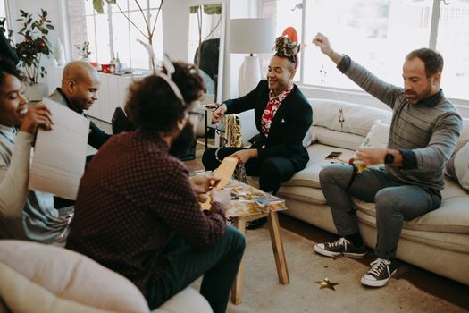 A cheerful group engaged in festive crafting activities indoors.