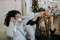 A Man and a Woman Covering their Face with Tinsels