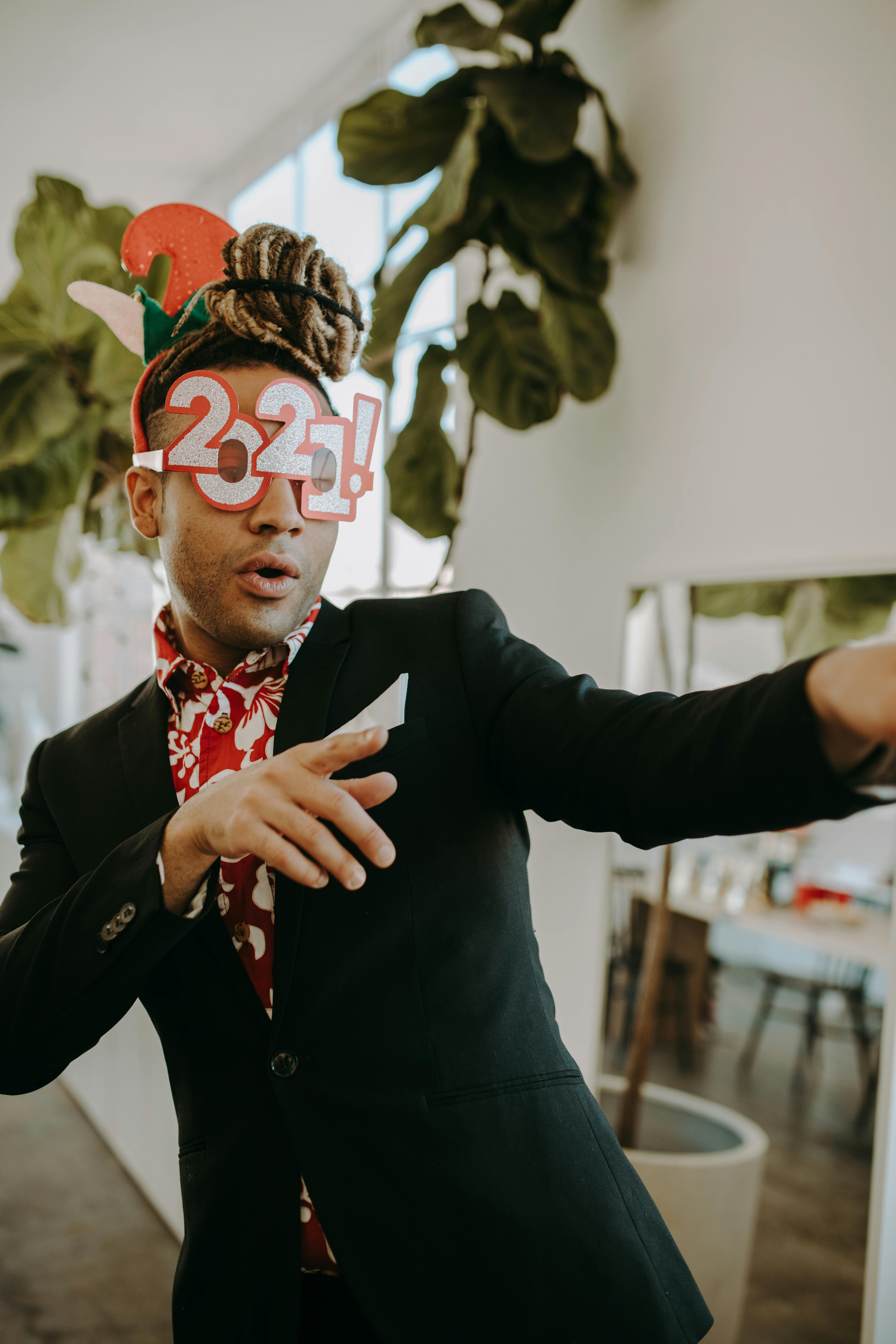 man in black coat wearing red and white floral button up shirt