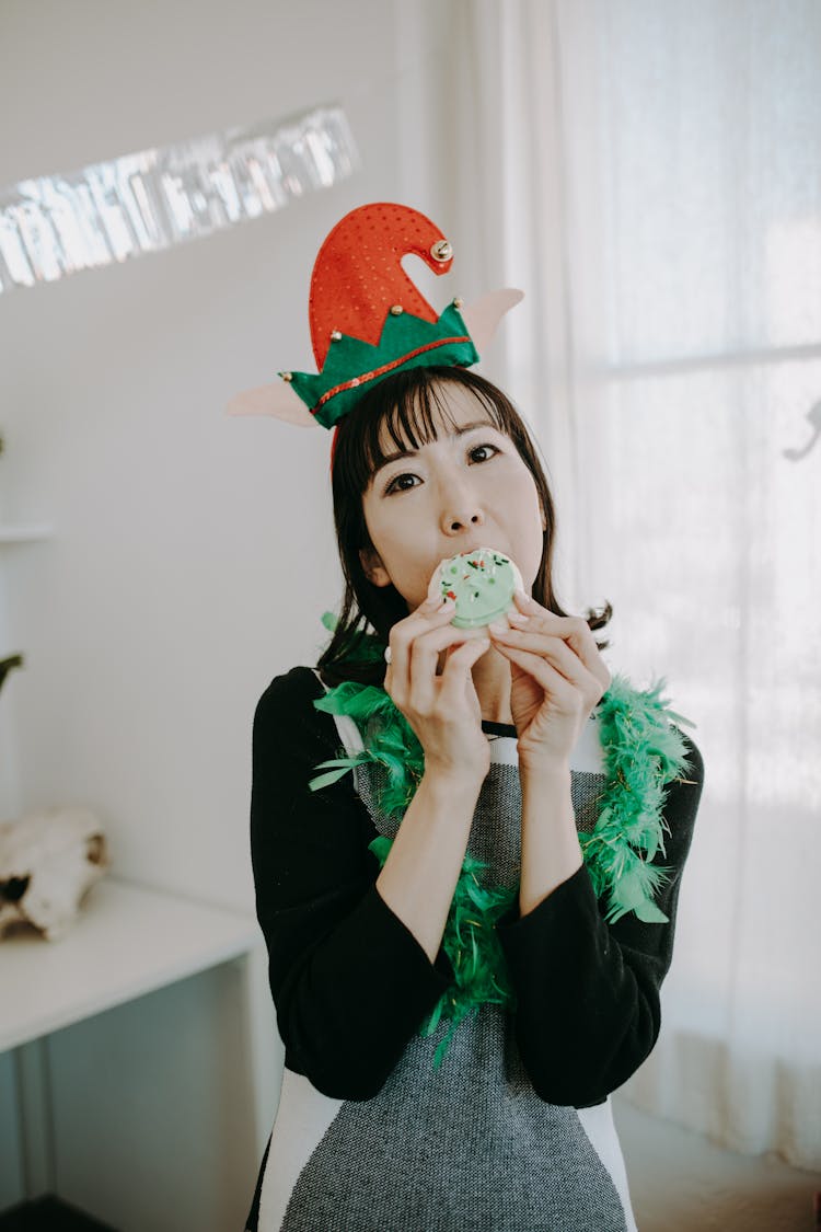 A Woman In Ugly Sweater While Eating Food