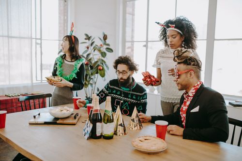 Free Diverse group of employees celebrating a holiday party in a bright office setting. Stock Photo