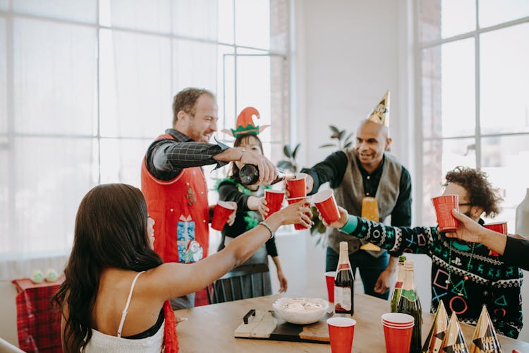 People Toasting Their Cups Of Wine