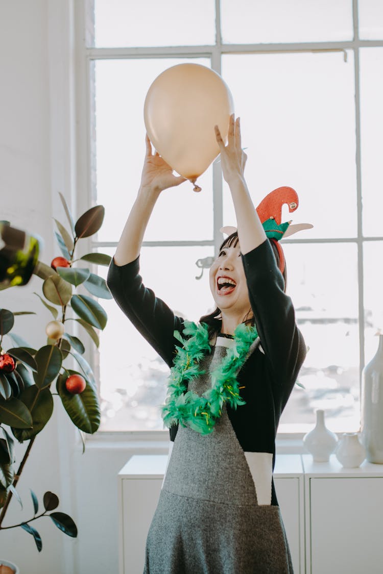 A Woman Holding A Balloon During A Party