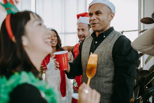 Free Man in Black Vest Holding Red Cup Stock Photo