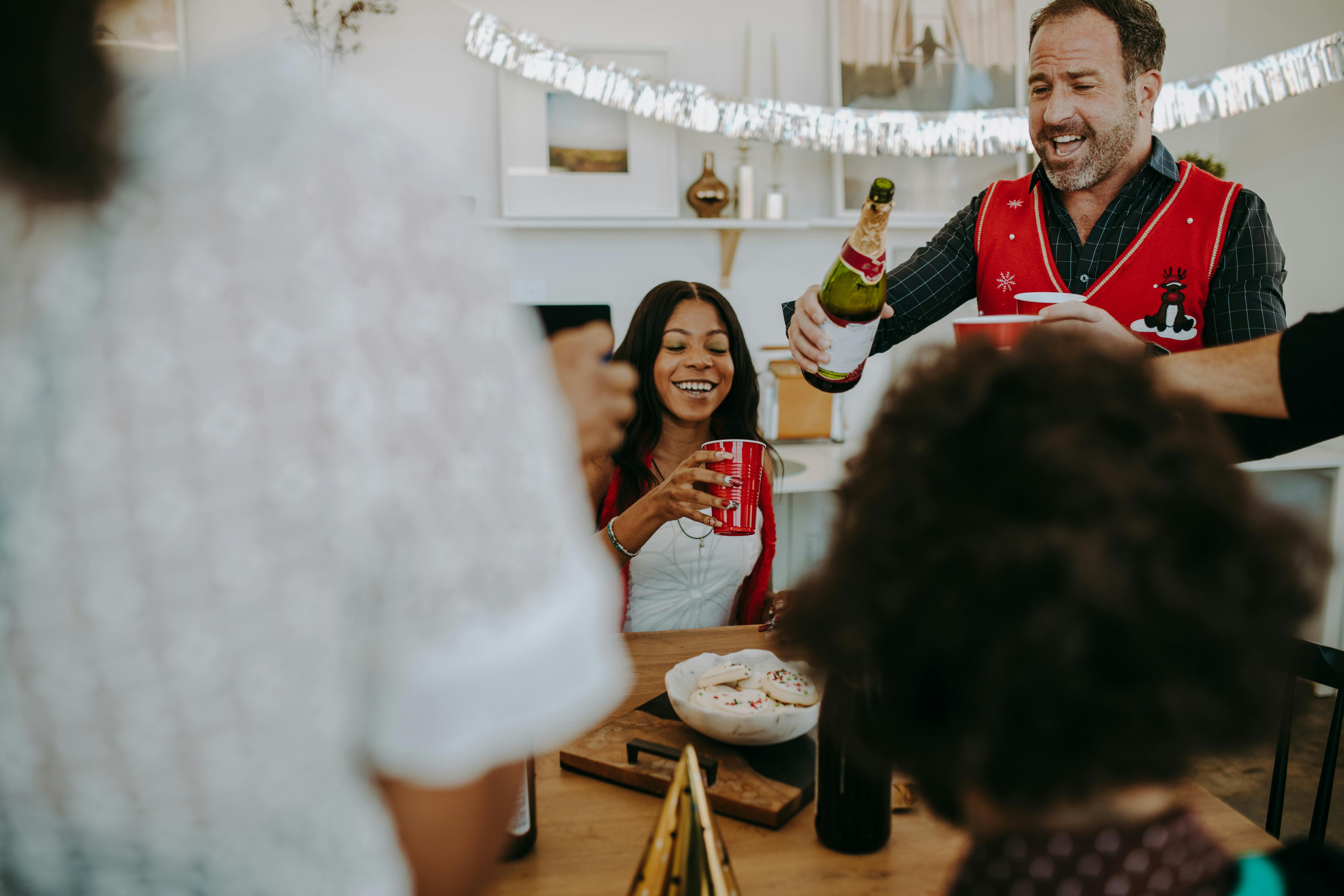 a man and woman holding drinks while having fun