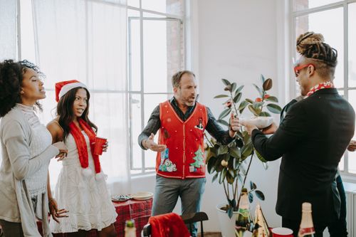 Free A lively office holiday party with coworkers enjoying festivities indoors. Stock Photo