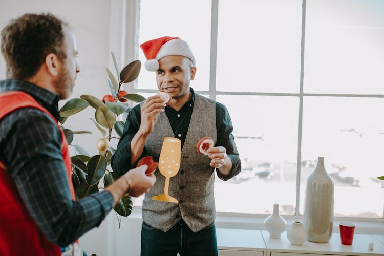 Man Wearing A Santa Hat Eating Dessert