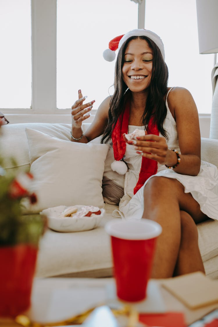 A Woman Smiling While Holding A Cookie