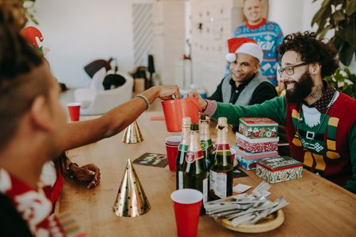 Free A joyful Christmas gathering with gift giving and holiday cheer at a cozy home setting. Stock Photo