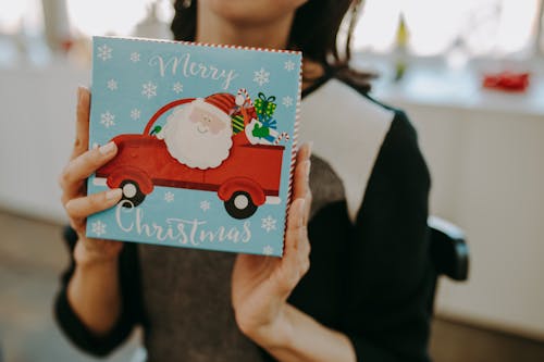 A Person Holding a Christmas Present