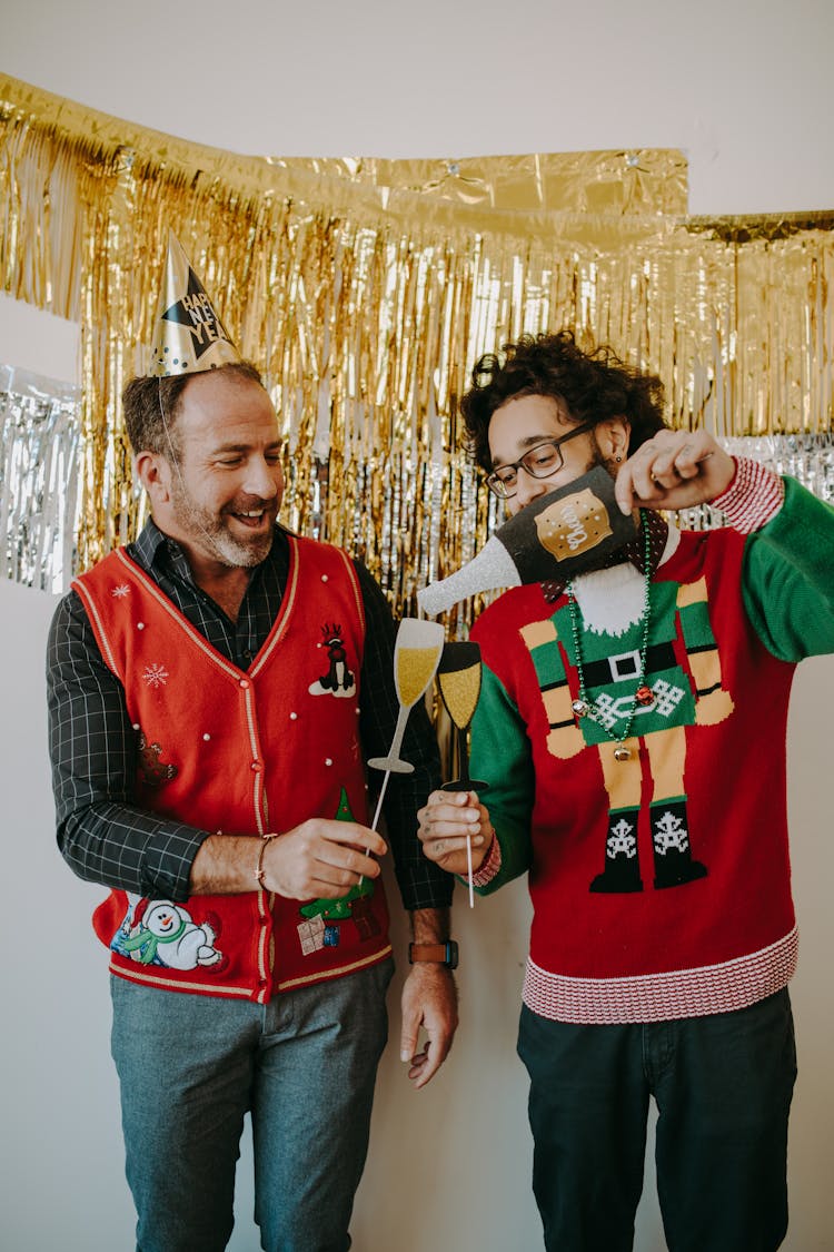 Smiling Man Wearing A Party Hat And A Christmas Vest