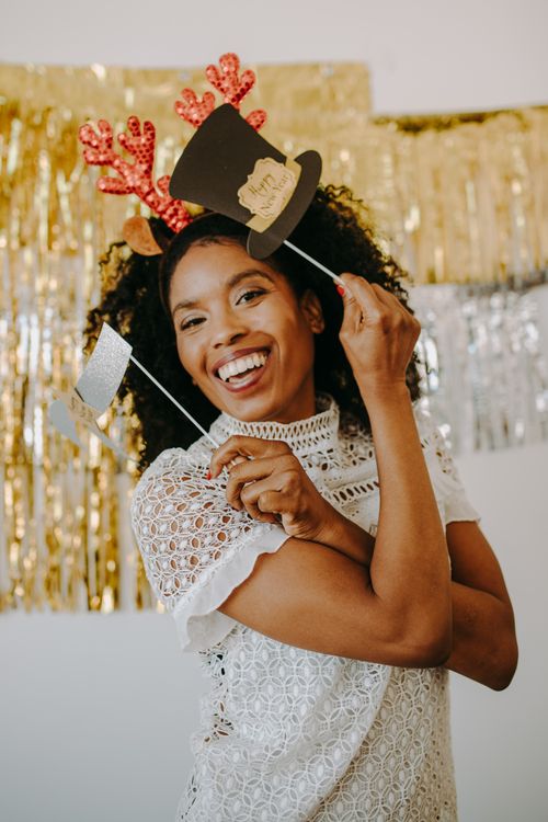 Free Joyful black woman in holiday attire posing for a festive celebration photo. Stock Photo