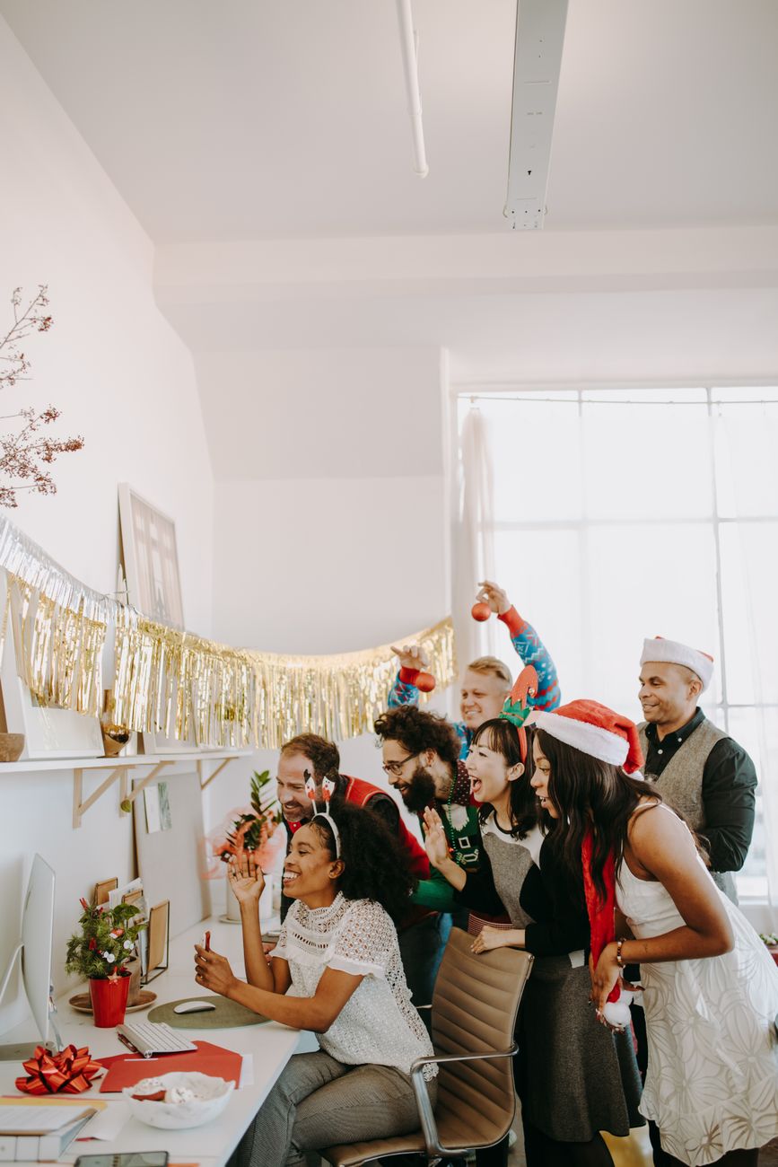 Colleagues celebrating at an office Christmas party with festive decorations