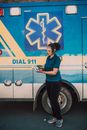 Paramedic Standing Beside an Ambulance