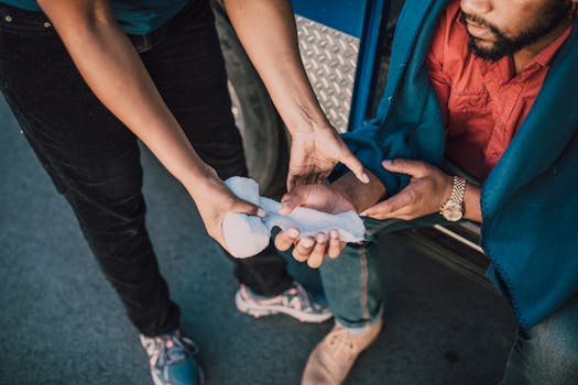 Close-up of a person applying gauze to an injured hand, highlighting first aid care.