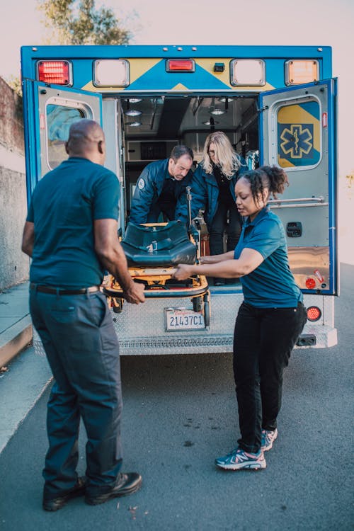 Free Paramedics Pulling Out a Stretcher Stock Photo