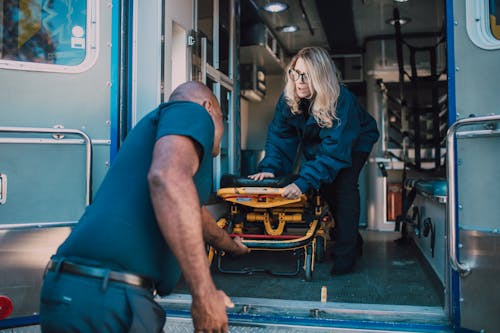 Free Man Pulling Out a Stretcher Stock Photo