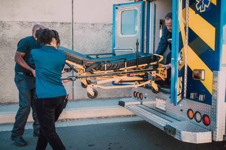 Paramedics Pulling Out A Stretcher From An Ambulance