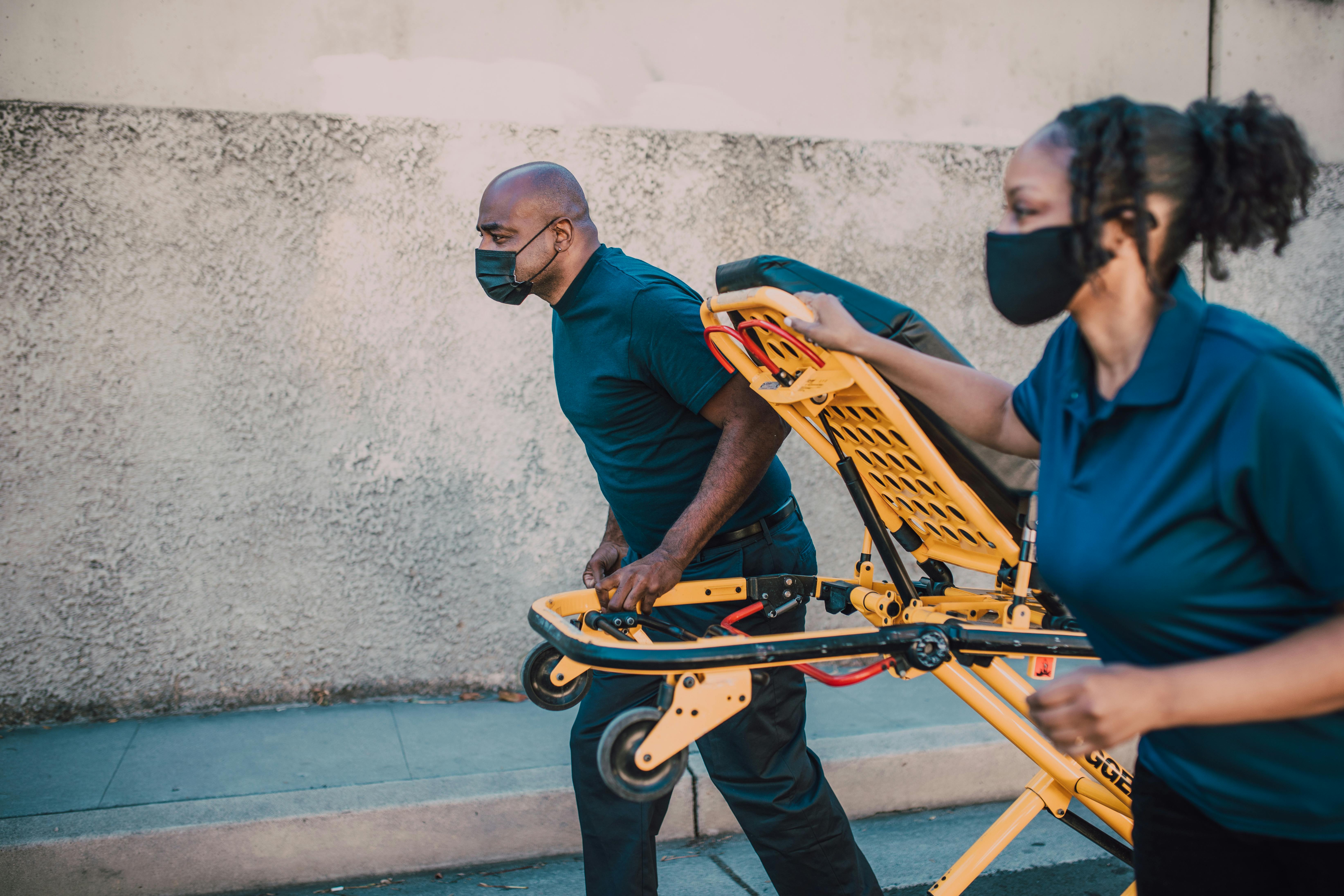 Paramedics Pulling a Stretcher · Free Stock Photo