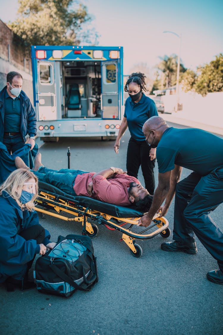 Paramedics Helping A Man On A Stretcher