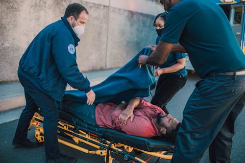 Free Paramedics Putting a Blanket on a Man's Body Stock Photo