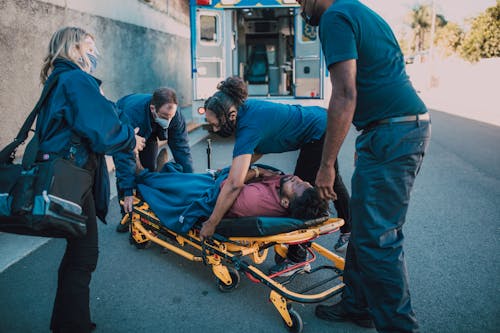 Free Paramedics Helping a Man on a Stretcher Stock Photo