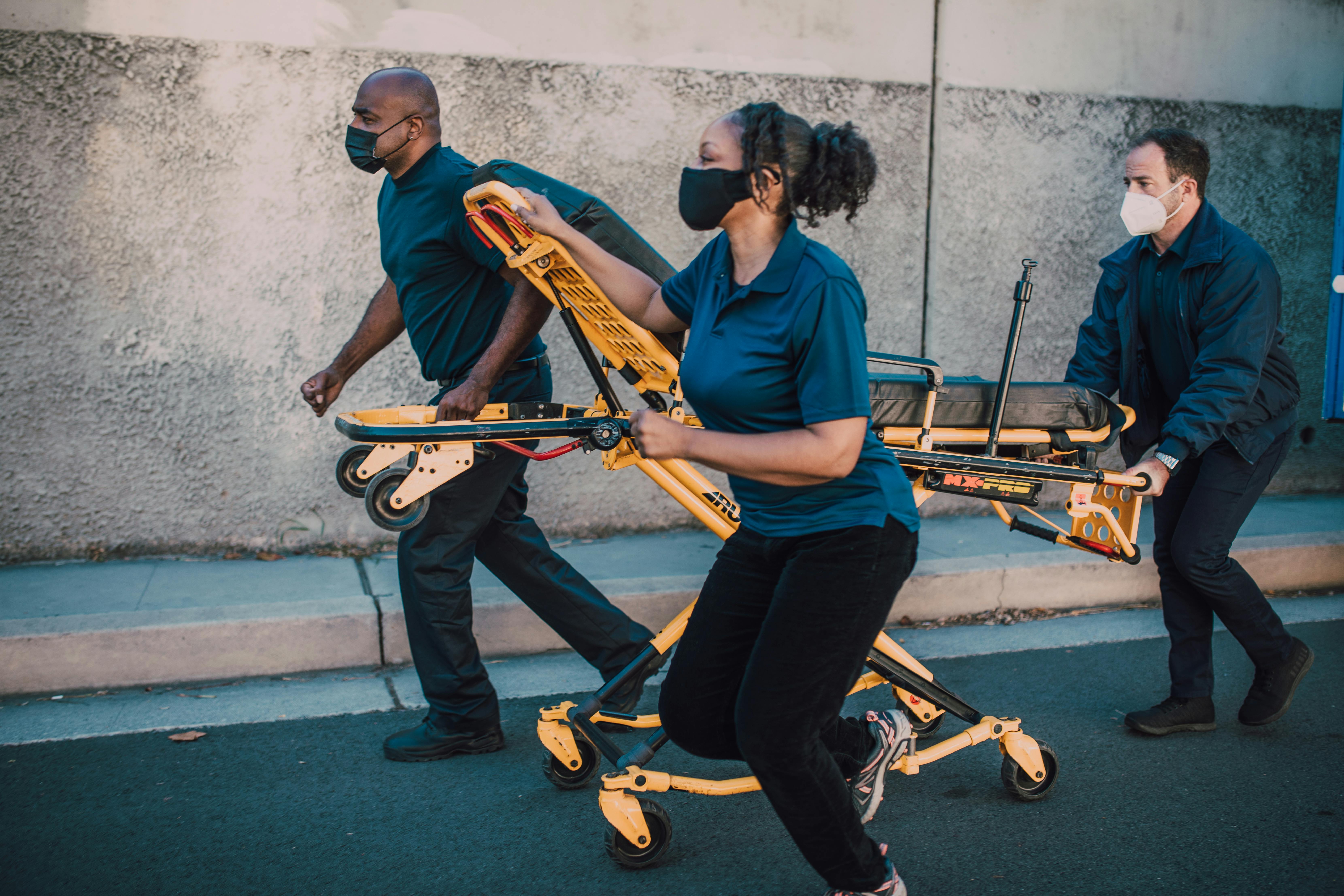 Paramedics Pushing A Stretcher · Free Stock Photo