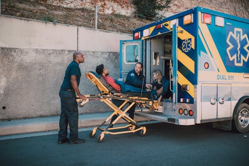 Free Paramedics Bringing Man in a Ambulance Stock Photo