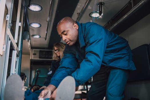Paramedics attending to a patient inside an ambulance, showcasing emergency medical care.