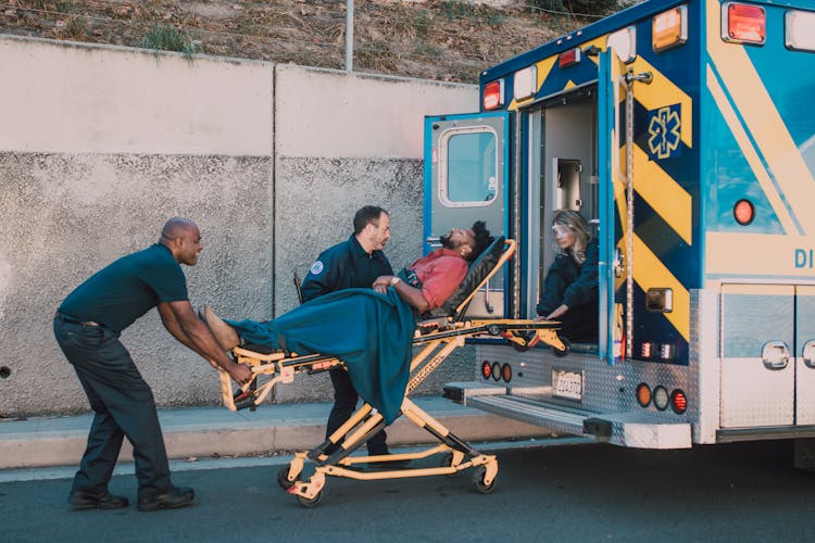 Paramedics Helping A Man On A Stretcher