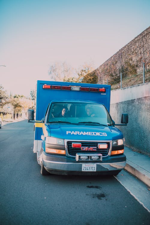 Blue Ambulance Parked on Side of a Road