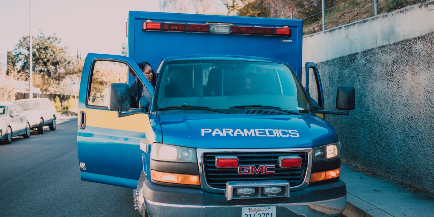 Front view of a paramedic ambulance parked on a city street.