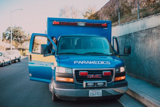 Front view of a paramedic ambulance parked on a city street.