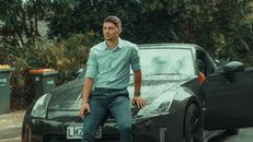 Man Sitting on a Black Car