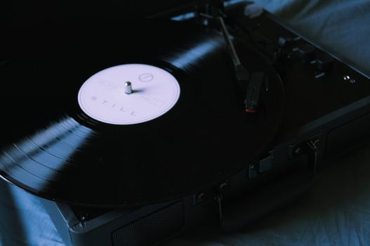 A classic vinyl record spinning on a vintage turntable, evoking nostalgia and analog charm.