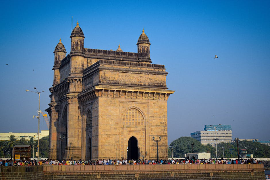 The iconic Gateway of India in Mumbai, a popular tourist attraction and historical landmark, on a sunny day.