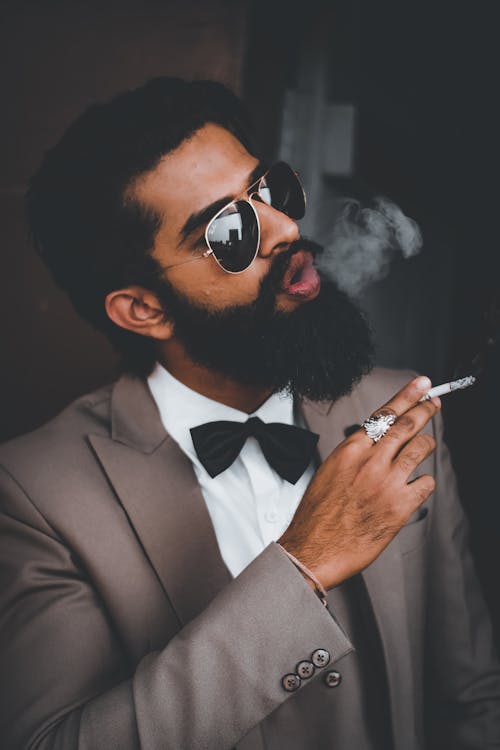 Man in Black Suit Smoking Cigarettes