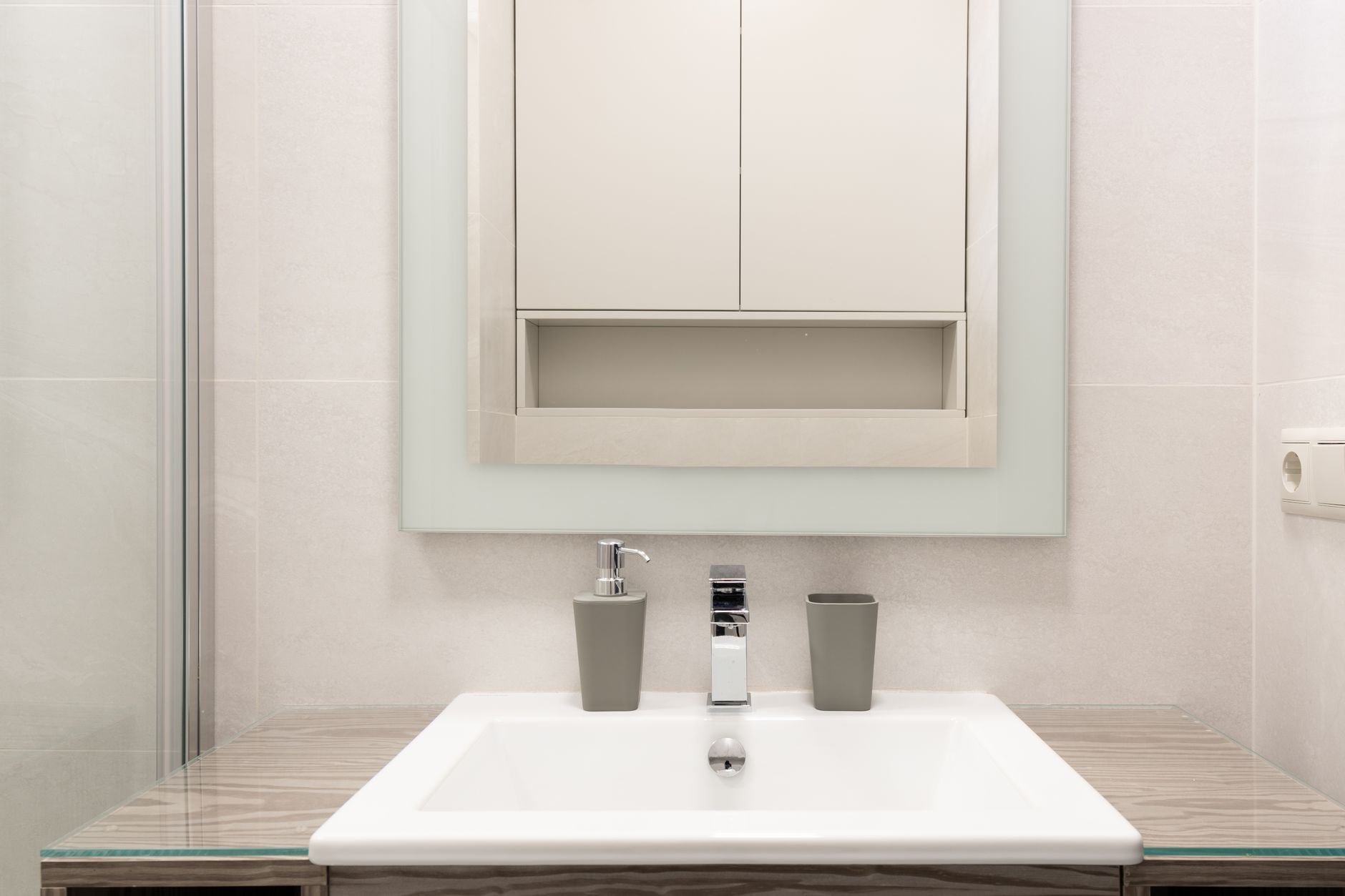 cozy bathroom storage that look expensive Modern interior of contemporary bathroom with simple minimal design with white shelf and walls