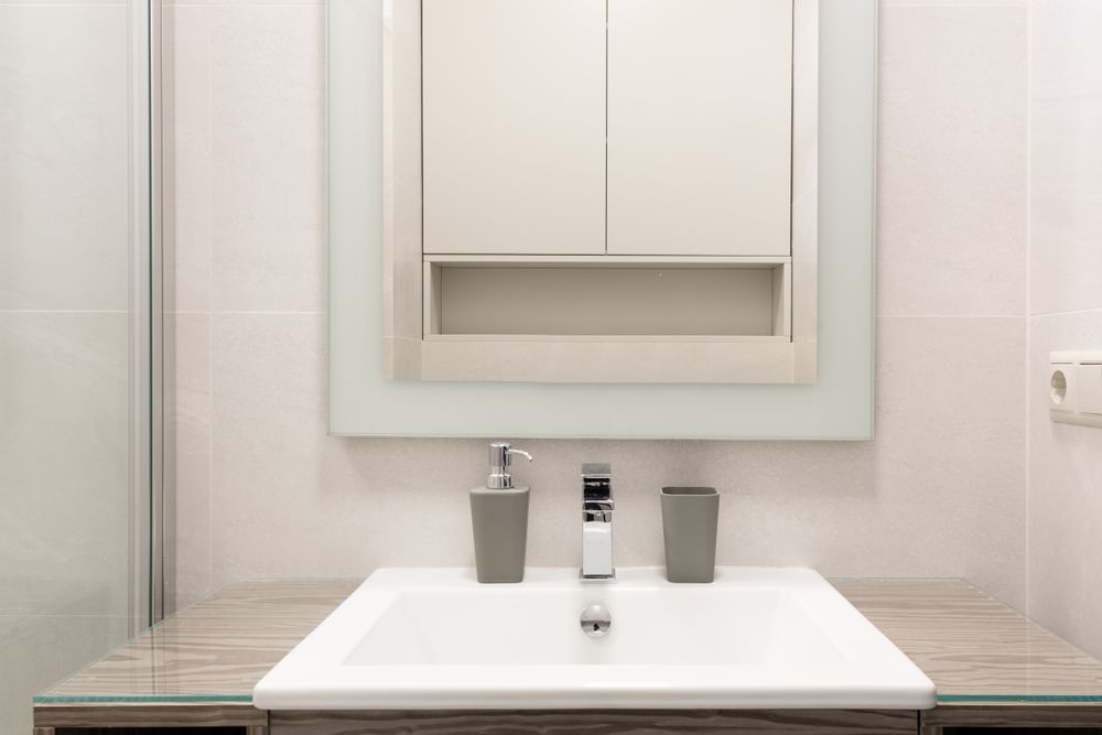 A bright bathroom with a white basin