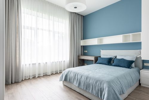 Free Comfortable bedroom with cozy bed and large window decorated with curtains in daylight Stock Photo