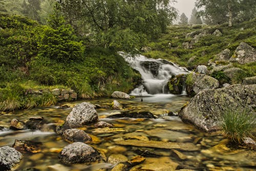 Free Long Exposure of Cascade flowing on Rocks  Stock Photo