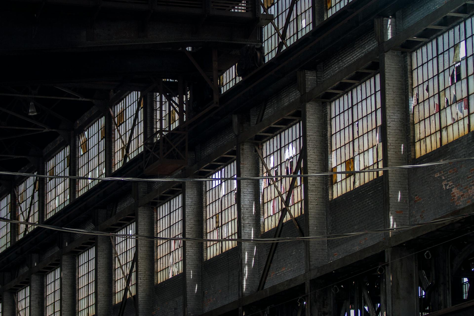 Interior view of a historic abandoned steel mill in Bethlehem, PA, with broken windows and steel structures.