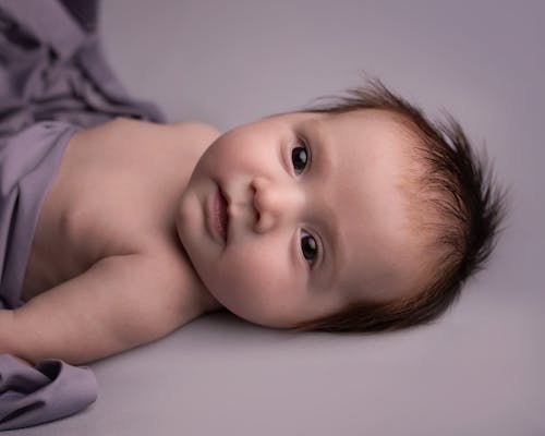 Free Close-Up Shot of a Baby Lying Down Stock Photo