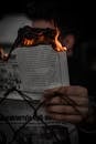 Close-Up of a Person Holding a Burning Newspaper