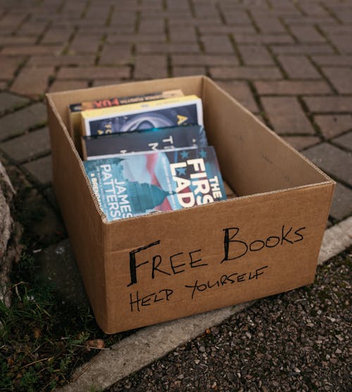 Free Giveaway Books on a Carton Box  Stock Photo