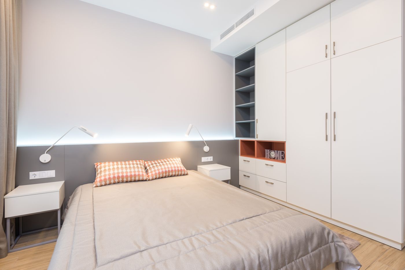 Modern cozy bedroom with bed and white wardrobe